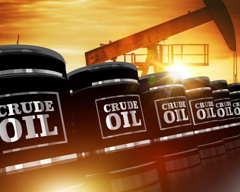 Crude oil barrels with pump jack at sunset representing oil trading and fuel industry